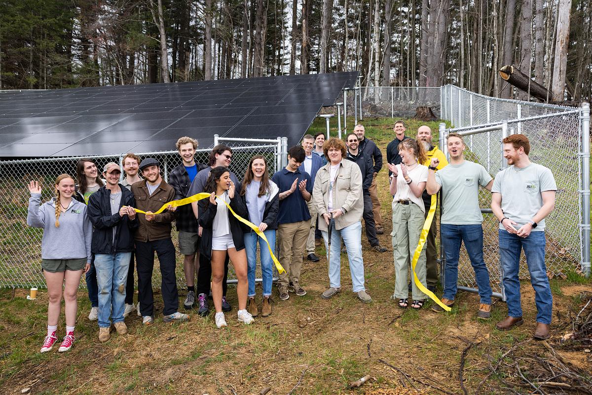 REI team at ribbon cutting for a solar project